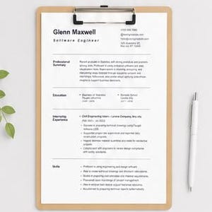 May include: A white resume document titled Glenn Maxwell Software Engineer secured on a light brown wooden clipboard with a black metal clip. The document contains sections for professional summary, education, experience, and skills, accompanied by a white pen.