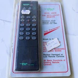 May include: A black Fox 400E remote control with multiple buttons, packaged with a card that reads "The Intelligent Remote." The card also states the remote combines four separate controls into one.