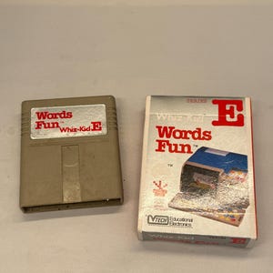 May include: A tan Whiz-Kid E cartridge and its box. The cartridge has the words "Words Fun" in red. The box features the same text, a blue and white illustration, and the VTech logo.