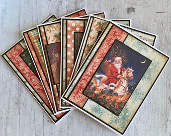 May include: Set of six Christmas cards featuring various holiday designs. One card features a Santa Claus riding a white horse with a bag of gifts. The cards have a rustic, vintage aesthetic with red, green, and brown colors.