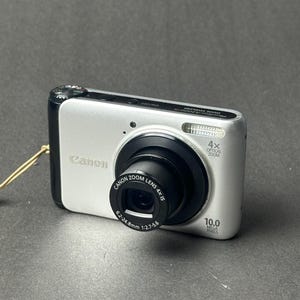 Cámara digital compacta Canon PowerShot A3000 IS con sensor CCD, color plata, probada y en funcionamiento.
