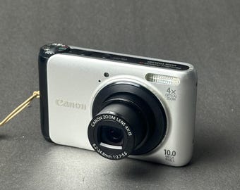 Appareil photo numérique compact Canon PowerShot A3000 IS, couleur argent, testé et fonctionnel.