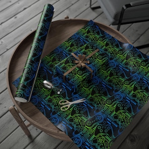 May include: Black wrapping paper with a neon blue and green video game controller design. A wrapped gift with a brown bow and scissors are on the paper. The words "NEW GAME" are visible.