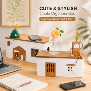 May include: Two rectangular cable organizer boxes shaped like small houses with white walls and wooden roofs. Each box features cutouts for cables, a decorative wooden door, and a window. One box has a green mountain figurine and the other a wooden robot.