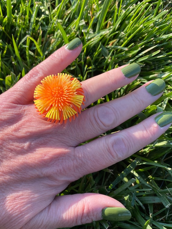 Ring-orange and yellow plastic flower