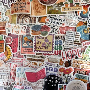 May include: A collection of assorted vinyl stickers featuring religious and inspirational themes. The stickers display various colorful illustrations including rainbows, flowers, butterflies, and open books, alongside text such as Walk by Faith, Hope, and He Left 99 to Find Me.
