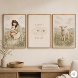 May include: A triptych of framed art prints. One print depicts a figure holding a lamb, another features the words "KNOWN. LOVED. CHOSEN.", and the third shows a lamb in a field. The prints have a neutral color palette with a soft, watercolor style.