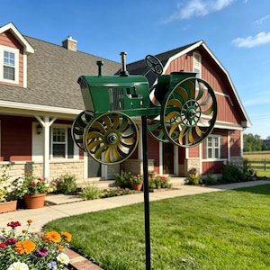 May include: A green metal tractor garden ornament with large, multi-coloured wheels. The tractor is mounted on a black pole in front of a red house with white trim and a green lawn. The wheels have a yellow and brown colour scheme.