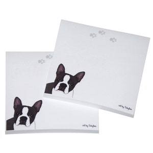 May include: Two white sticky note pads with a black and white illustration of a Boston Terrier dog on each pad. The text "art by Sayfla" is printed on each pad.