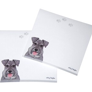 May include: Two white notepad sets with a gray and white illustration of a miniature schnauzer dog. The notepad sets have the text "art by Sallyjane" printed on the bottom.