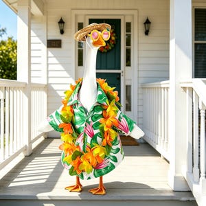 May include: A white goose figure, wearing a Hawaiian shirt with a tropical leaf pattern, a straw hat, and pink sunglasses. It has a colourful lei and stands on a porch, creating a whimsical, holiday-themed display.