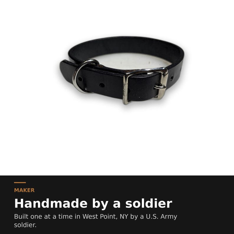 May include: A black leather collar featuring a silver-toned metal buckle and a D-ring. The text below reads: MAKER Handmade by a soldier Built one at a time in West Point, NY by a U.S. Army soldier.