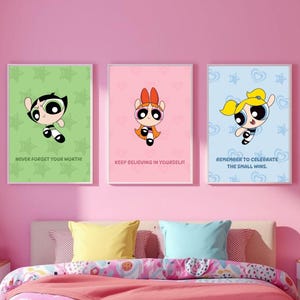May include: Three framed Powerpuff Girls art prints. Each print features a different character on a colored background with a motivational quote: "Never Forget Your Worth!", "Keep Believing in Yourself!", and "Remember to Celebrate the Small Wins."