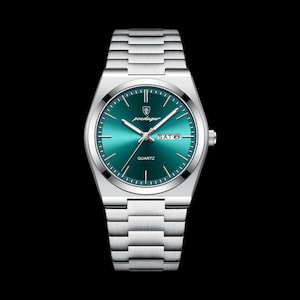 May include: A silver wristwatch with a teal-green face and a matching metal strap. The watch face displays the day of the week and the word "QUARTZ". The watch has a sleek, modern design.