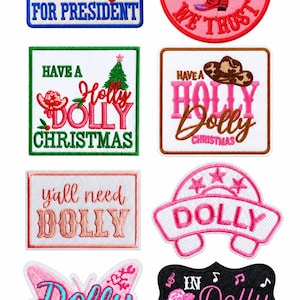 May include: A collection of eight embroidered patches featuring various designs and text including Dolly for President, In Dolly We Trust with a cowboy boot, Have a Holly Dolly Christmas, y'all need DOLLY, a butterfly, and musical notes.