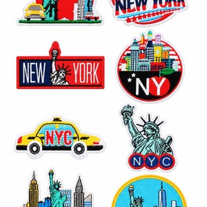 May include: A collection of eight embroidered patches featuring New York City themes, including the Statue of Liberty, yellow taxis, city skylines, and red apples. The designs incorporate text such as NEW YORK, NY, and NYC in various colors and shapes.
