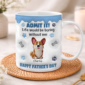 May include: White ceramic mug with a blue rim and handle, featuring a smiling corgi illustration and the text "ADMIT IT! Life would be boring without me." Includes paw prints, a star, and the words "Happy Father's Day."