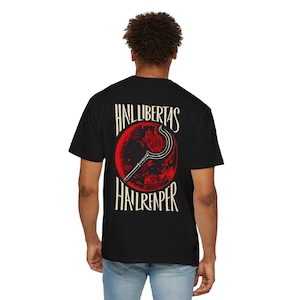 May include: Black t-shirt with a red graphic of a scythe inside a red circle. The text "HAIL LIBERTAS" is arched above the circle, and "HAIL REAPER" is below. The shirt is worn by a person.