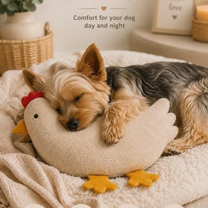 May include: A beige plush chicken toy with a red comb, yellow beak, and yellow feet. The toy features a soft, textured fabric surface and is shaped like a rounded bird. The text on the image reads: SOFT & COZY SLEEP TOY, Comfort for your dog day and night.