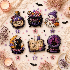 May include: Six acrylic charms featuring Halloween designs: a potion bottle labeled Moonlit Magic, a cauldron with Sugar & Spells, a ghost with a pumpkin, a black cat on a crescent moon labeled Midnight Cutie, a book labeled Hexed & Cozy, and a crystal ball labeled Haunted Dreams.