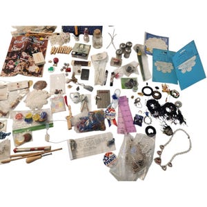 May include: A collection of assorted craft supplies including lace doilies, buttons, sewing notions, jewelry components, a Ross Perot 92 campaign button, miniature figurines, and various packaged sewing accessories spread across a flat surface.