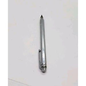 May include: A silver mechanical pencil with a hexagonal barrel and a pocket clip. The pencil has a black tip and a rounded end. The pencil is made of metal and has a shiny finish.