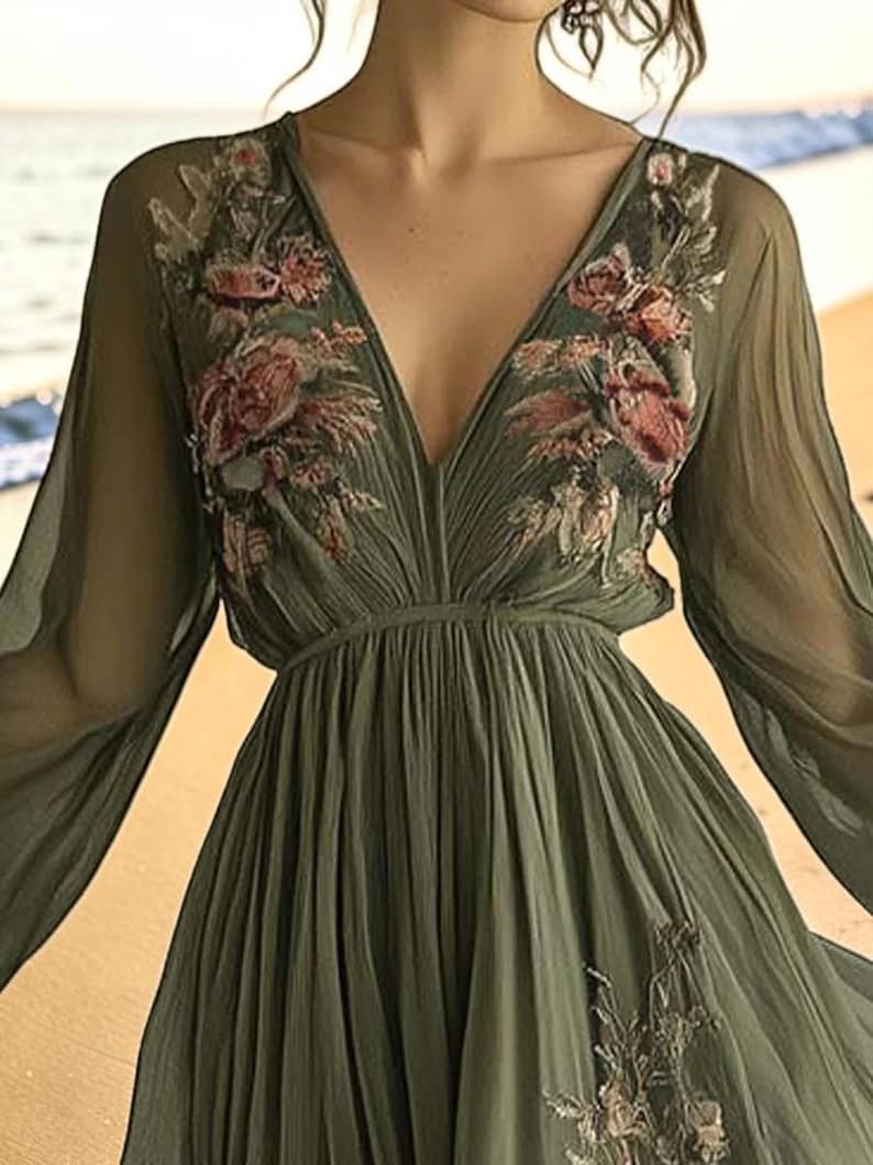 May include: Olive green chiffon dress with a deep V-neckline and long, flowing sleeves. The bodice and sleeves are adorned with embroidered floral details in shades of pink and red. The dress has a gathered waist and a flowing skirt.
