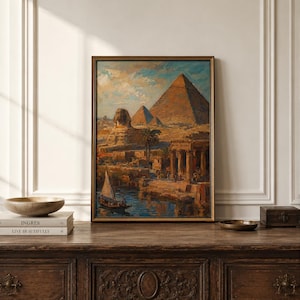 May include: A framed oil painting depicting the Great Sphinx and pyramids of Giza in Egypt. The scene features a river with a small sailboat in the foreground, ancient stone structures, palm trees, and a warm, textured sky with blue and gold tones.