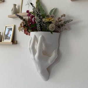 May include: A trio of ceramic mugs with a speckled, matte finish in light blue, cream, and grey. The mugs have a simple, modern design, ideal for coffee or tea.