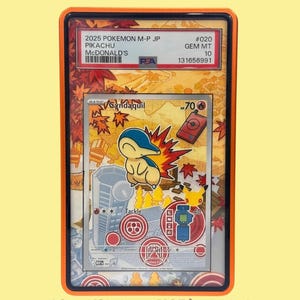 May include: A graded Cyndaquil trading card in a protective plastic slab with an orange border. The card features a yellow and blue Cyndaquil character, red maple leaves, and game icons. The PSA label at the top reads 2025 POKEMON M-P JP PIKACHU.