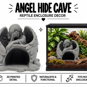 May include: A gray 3D printed reptile hide cave shaped like a mourning angel with large wings. The text ANGEL HIDE CAVE REPTILE ENCLOSURE DECOR is visible. The cave is shown inside a glass terrarium with plants, soil, and wood.