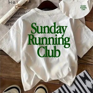 May include: A white short-sleeve t-shirt featuring the text "Sunday Running Club" in large dark green letters on the back. A smaller version of the same green text is printed on the front chest area of the shirt, which is displayed on a hanger.