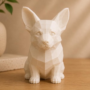 May include: A cream-colored, low-poly geometric figurine of a Corgi dog. The sculpture features a faceted, angular surface design with pointed ears, a defined snout, and a seated posture, rendered in a solid, matte, light-toned material.