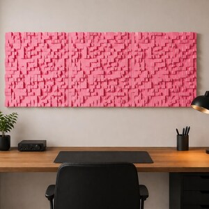 May include: A large rectangular wall art piece composed of numerous small, protruding pink wooden blocks of varying heights and widths, creating a textured, three-dimensional surface mounted horizontally on a plain wall.