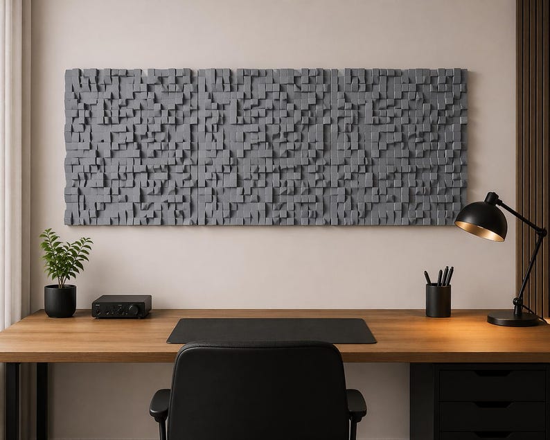 May include: A large rectangular wall art piece composed of numerous small, gray, protruding wooden blocks of varying depths and sizes, creating a textured, three-dimensional surface mounted horizontally above a wooden desk.