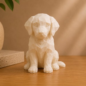 May include: A cream-colored, geometric-style dog figurine featuring a faceted, low-poly design. The sculpture depicts a puppy in a seated position with floppy ears, a smooth surface, and sharp, angular edges forming its body and facial features.