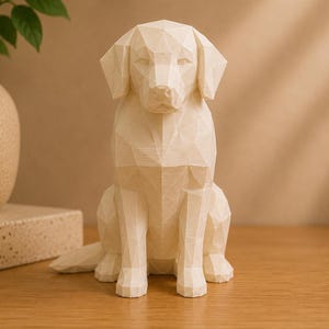 May include: A cream-colored, low-poly geometric sculpture of a sitting dog. The figure is constructed from numerous flat, triangular facets that form the shape of the canine's head, ears, body, and legs, creating a sharp, angular appearance.