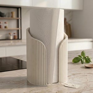 May include: A cream-colored, cylindrical paper towel holder featuring a vertical ribbed texture. The holder contains a roll of white paper towels embossed with a subtle leaf pattern and includes a small, rectangular paper tag attached at the base.