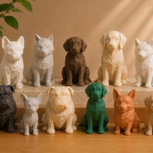 May include: A collection of eleven geometric dog figurines in various colors including white, black, brown, green, and orange. Each statue features a faceted, low-poly design representing different dog breeds sitting in an upright position.