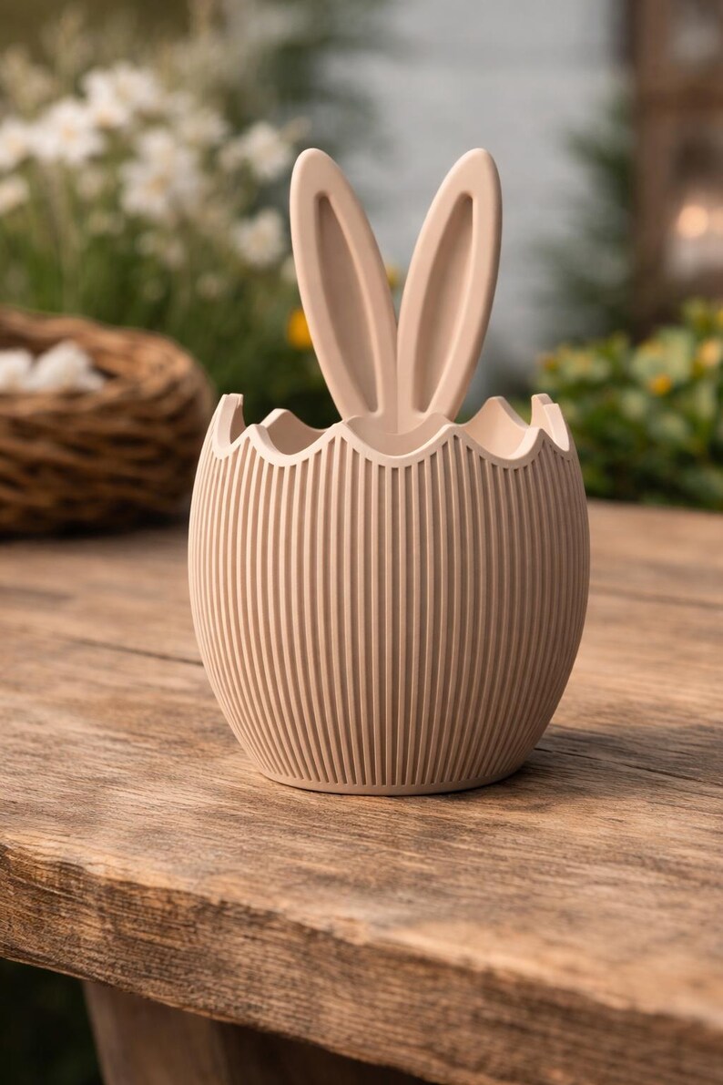 May include: A set of three ceramic mugs with a speckled, matte finish. The mugs are in cream, light grey, and dark grey. Each mug has a simple, minimalist design, ideal for coffee or tea.