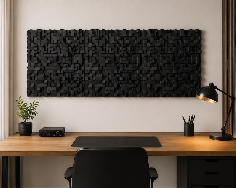 May include: A large, rectangular, black wall art piece composed of numerous small, protruding wooden blocks of varying heights and widths, creating a textured, three-dimensional surface mounted horizontally above a wooden desk.