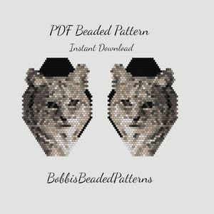 May include: A PDF beaded pattern featuring two pixelated wolf head designs in shades of gray, white, and black. The text reads PDF Beaded Pattern, Instant Download, and BobbisBeadedPatterns. The wolf heads are symmetrical with black ears.