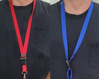 May include: A red lanyard with a black plastic clasp and a silver-colored metal hook. The lanyard is worn around the neck. A blue lanyard with a black plastic clasp and a silver-colored metal hook is also shown.