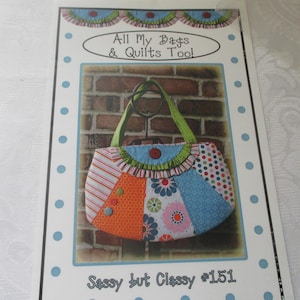 May include: A sewing pattern titled "All My Bags & Quilts Tool" featuring a colorful patchwork handbag design. The bag has orange, blue, and floral patterned sections, with a green handle and a brick background. The text "Sassy but Classy #151" is at the bottom.