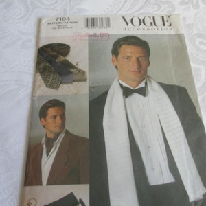 May include: A set of three ceramic mugs with a speckled, cream-colored glaze. Each mug features a different hand-painted floral design in shades of blue, green, and yellow. The mugs have a simple, rounded shape and a comfortable handle.