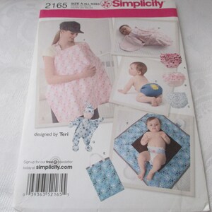 May include: Simplicity sewing pattern number 2165 for baby clothes. The pattern includes instructions for making a nursing cover, a baby sleeping bag, a diaper cover, a baby doll, and a changing mat. The pattern is designed by Teri.