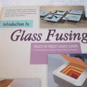May include: A book titled "Introduction to Glass Fusing" with the subtitle "Project-by-Project Guided Lessons." The cover features images of fused glass art and a kiln. The book is a comprehensive guide to glass fusing techniques.
