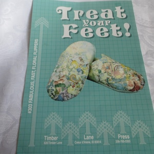 May include: A pair of floral patterned slippers with the text "Treat your Feet!" and "#303 FABULOUS, FAST, FLORAL FLIPPERS" on a turquoise background.