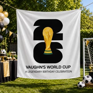 May include: A white fabric backdrop featuring large black numbers 2026 with a gold-colored trophy illustration replacing the zero. The text reads VAUGHN'S WORLD CUP A LEGENDARY BIRTHDAY CELEBRATION in black capital letters centered below the graphic.