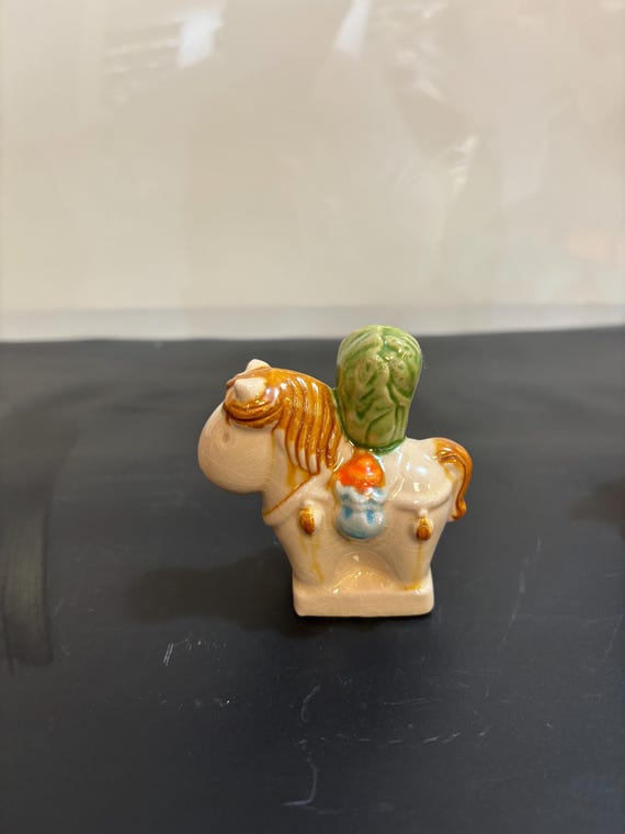 A miniature hand-sculpted ceramic Tang Sancai horse — one of the most recognizable icons of classical Chinese art, recreated in an authentic glazed style that belongs in a museum vitrine.
